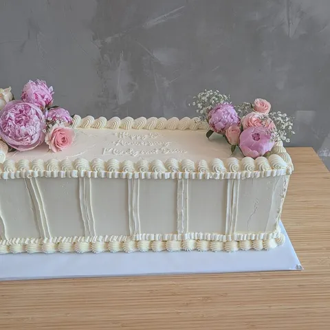 Ivory sheet cake with piped borders and pink peonies